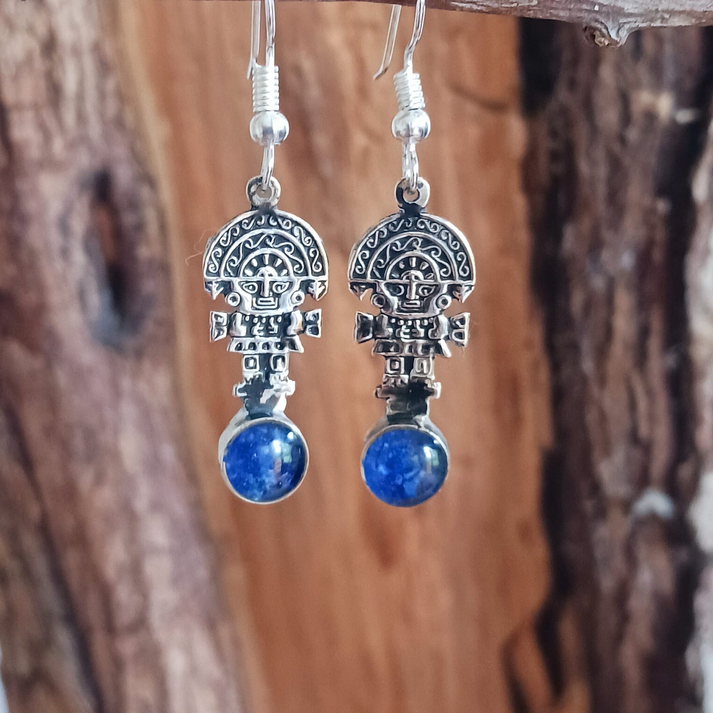 These intricate earrings feature a tiny image of the Tumi, a type of ceremonial knife used in ancient Peru by the Moche culture. They feature a mythical character usually identified with the god Naymlap. All hooks are silver plated and these earrings come with crushed lapis lazuli stone. Ideal for a night out, for dressing up your boho look or as a gift for family or friends.