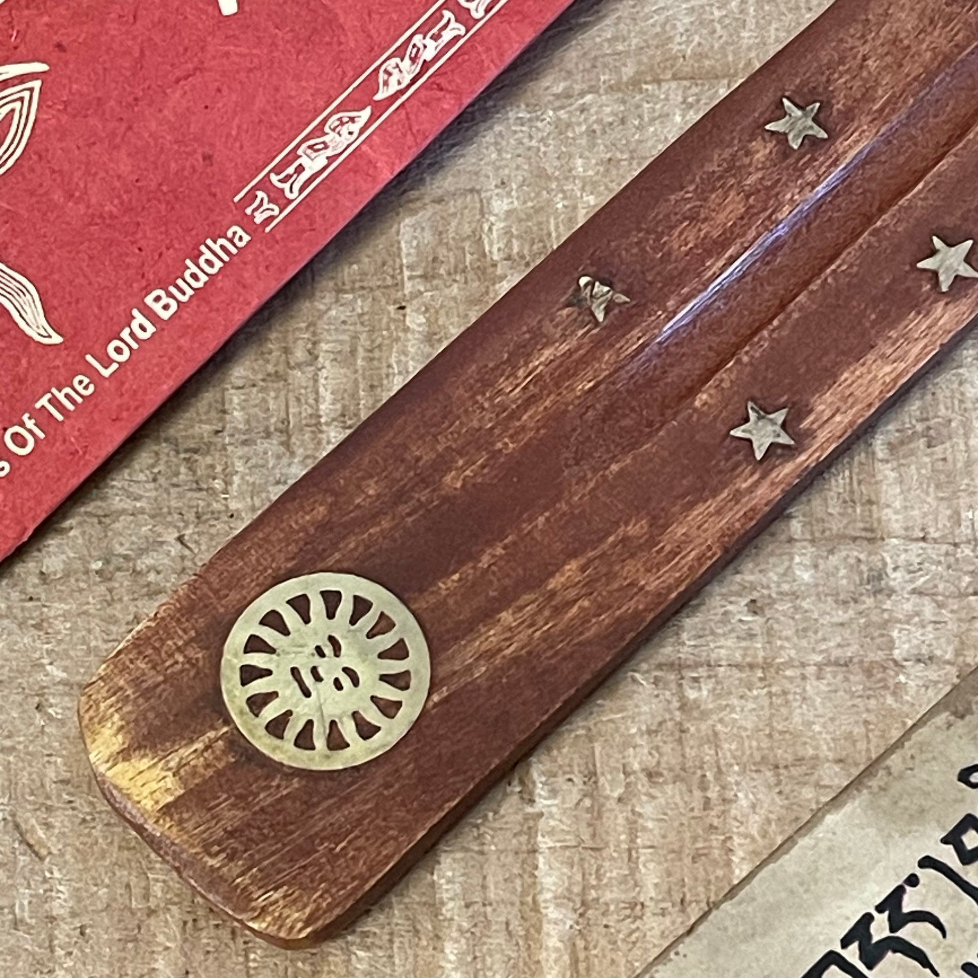 Discover our most popular incense holder yet: a stunning shoe horn-style ash catcher crafted from mango wood. Designed specifically for stick incense, this elegant piece features beautiful inlays of stars and a radiant sun.
The incense lays gracefully over the wooden body, allowing ash to collect neatly as it falls, ensuring your space remains clean and inviting.