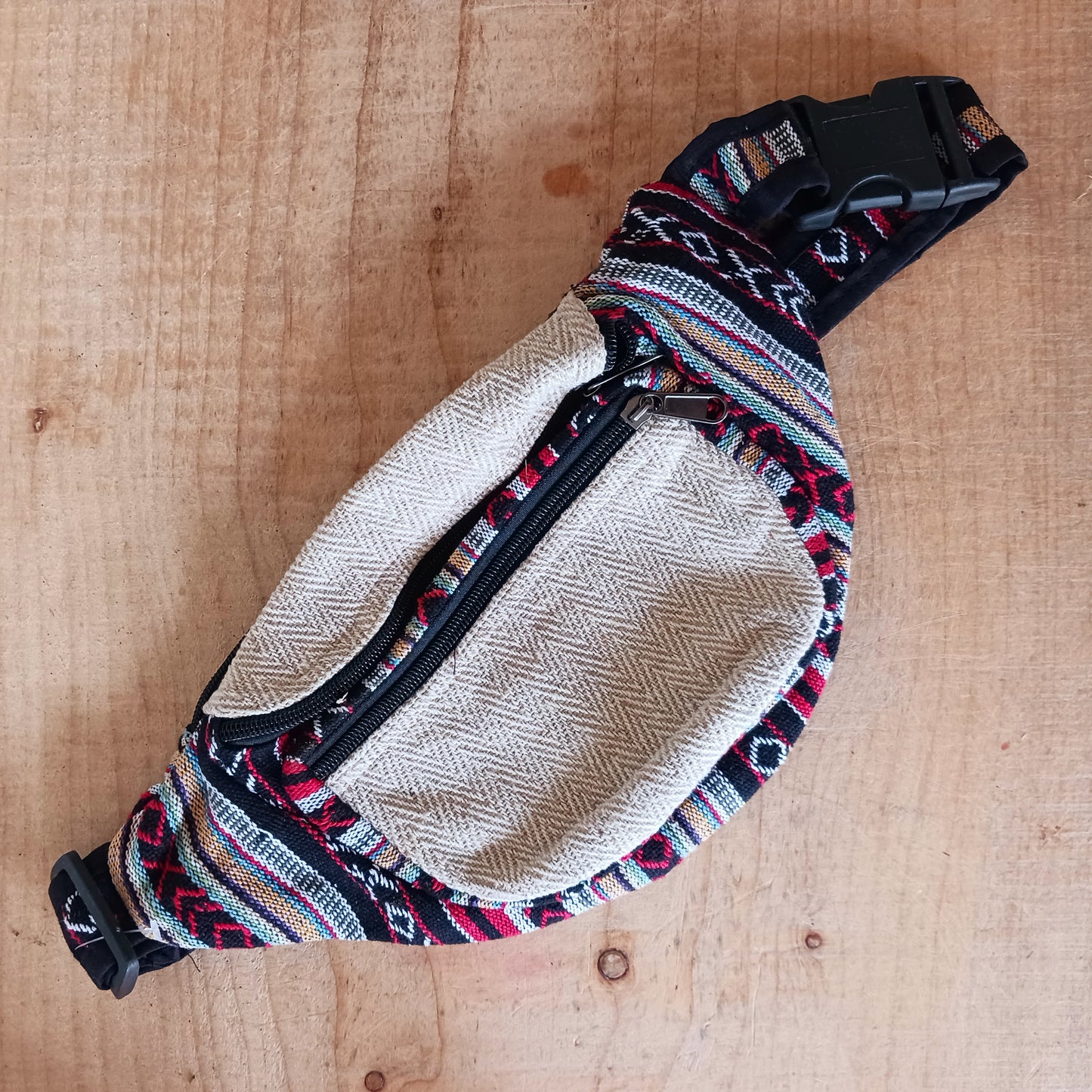 These brilliant bum bags are the perfect bit of kit for festivals or travelling. Made from a hard wearing mix of hemp and bold, colourful gheri cotton, each bag has two large zipped compartments, a zipped inside note pocket and an adjustable waist strap. Please be aware that our patchwork products are made using up scraps of fabric that would otherwise be wasted. This means that each item is unique.
