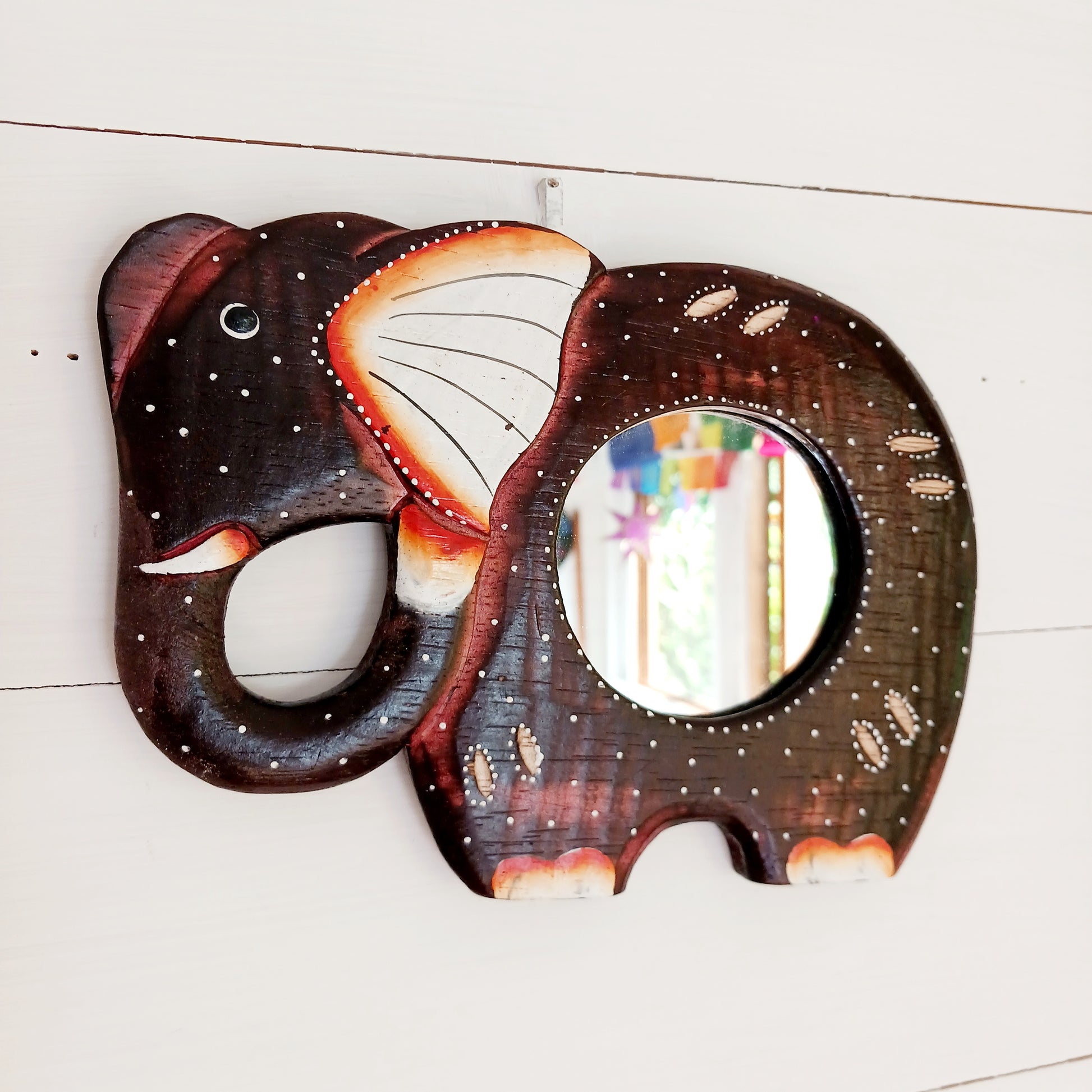 These beautiful little hand carved and hand painted mirrors depict an elephant with gorgeous dot painted detailing.  A cute little gift for elephant lovers!   Each mirror has a metal hoop on the reverse for ease of hanging.