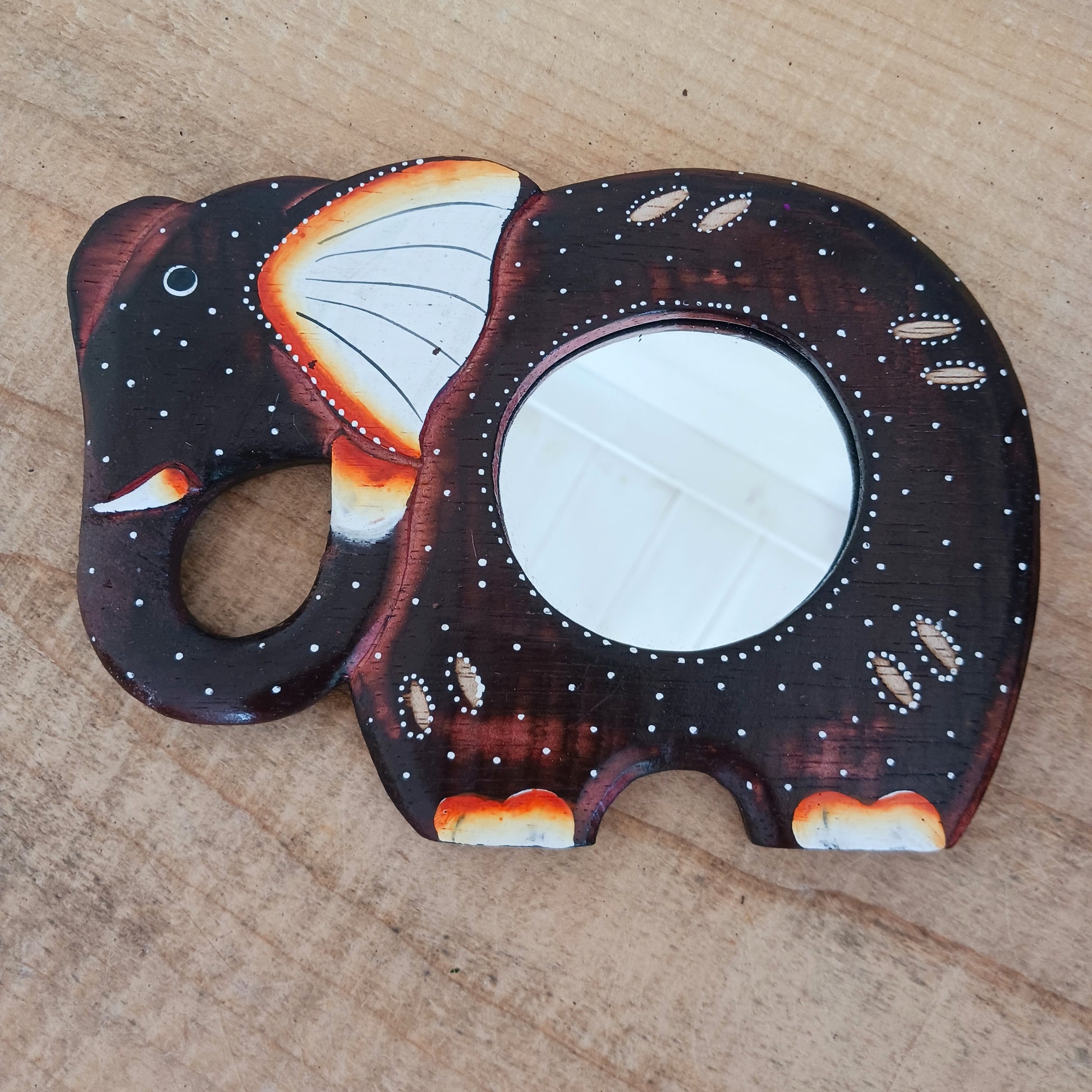 These beautiful little hand carved and hand painted mirrors depict an elephant with gorgeous dot painted detailing.  A cute little gift for elephant lovers!   Each mirror has a metal hoop on the reverse for ease of hanging.
