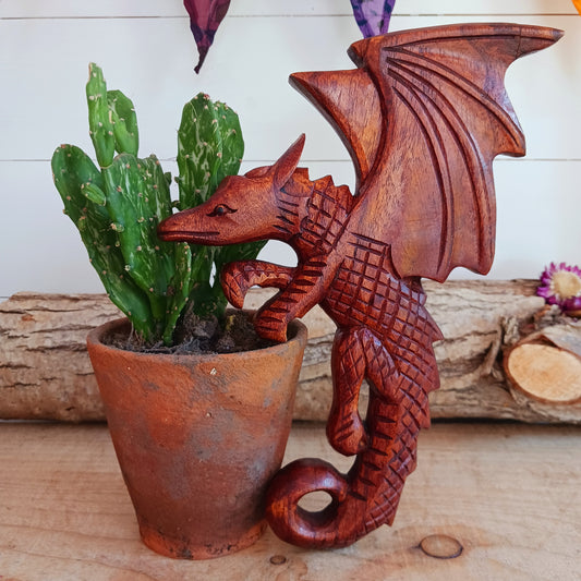 This intricately carved Dragon plaque sit flush against the wall or can be hooked onto pots or some other items in the home.  These Dragons are hand carved with metal hook for hanging if you choose.  In early cultures, the dragons were often seen as mighty serpents and beasts that were either extremely benevolent or fearsome and difficult to kill. The beliefs of a region are often influenced by geographical location. Eastern cultures often saw dragons as a knowledgeable deity that had power over storms