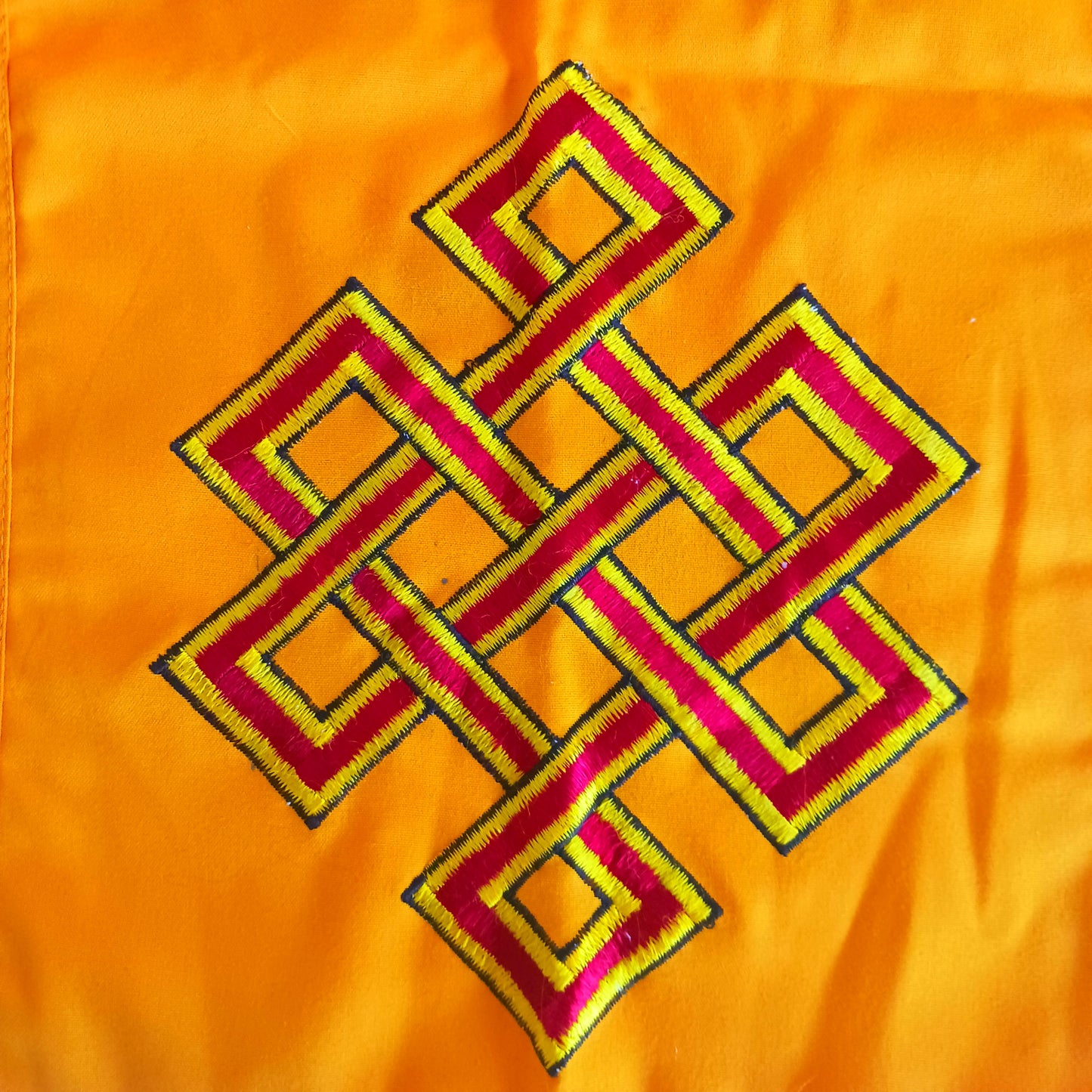 The knot of Infinity is the representation of the interdependence of all phenomena, represented by the intertwined lines.
