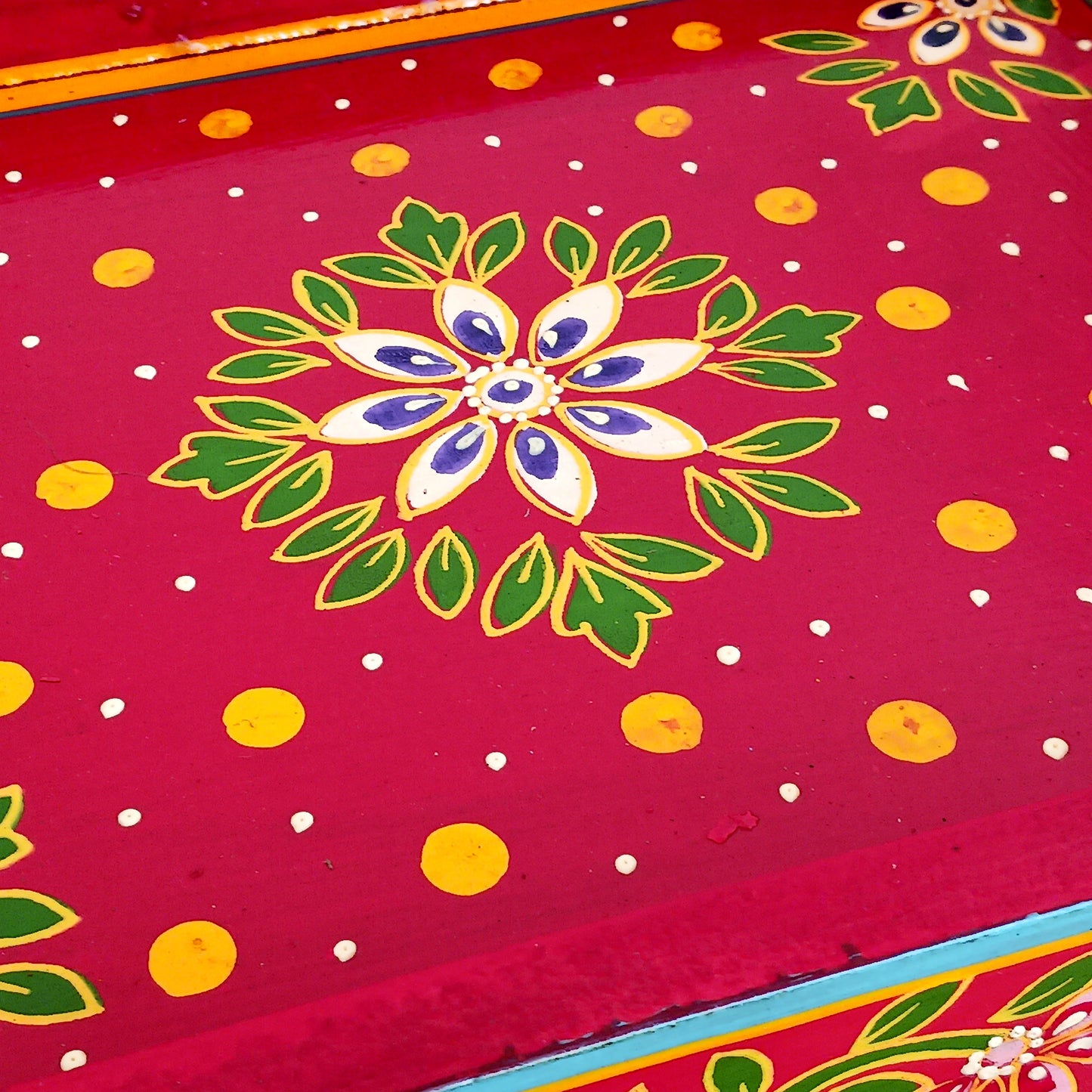 A beautiful peacock design, hand painted jewellery box in a palette of regal reds and blues made from sustainable mango wood. This lovely box comprises a top opening section with mirror, and a single drawer; two useful compartments, accessed with discreet round knobs.