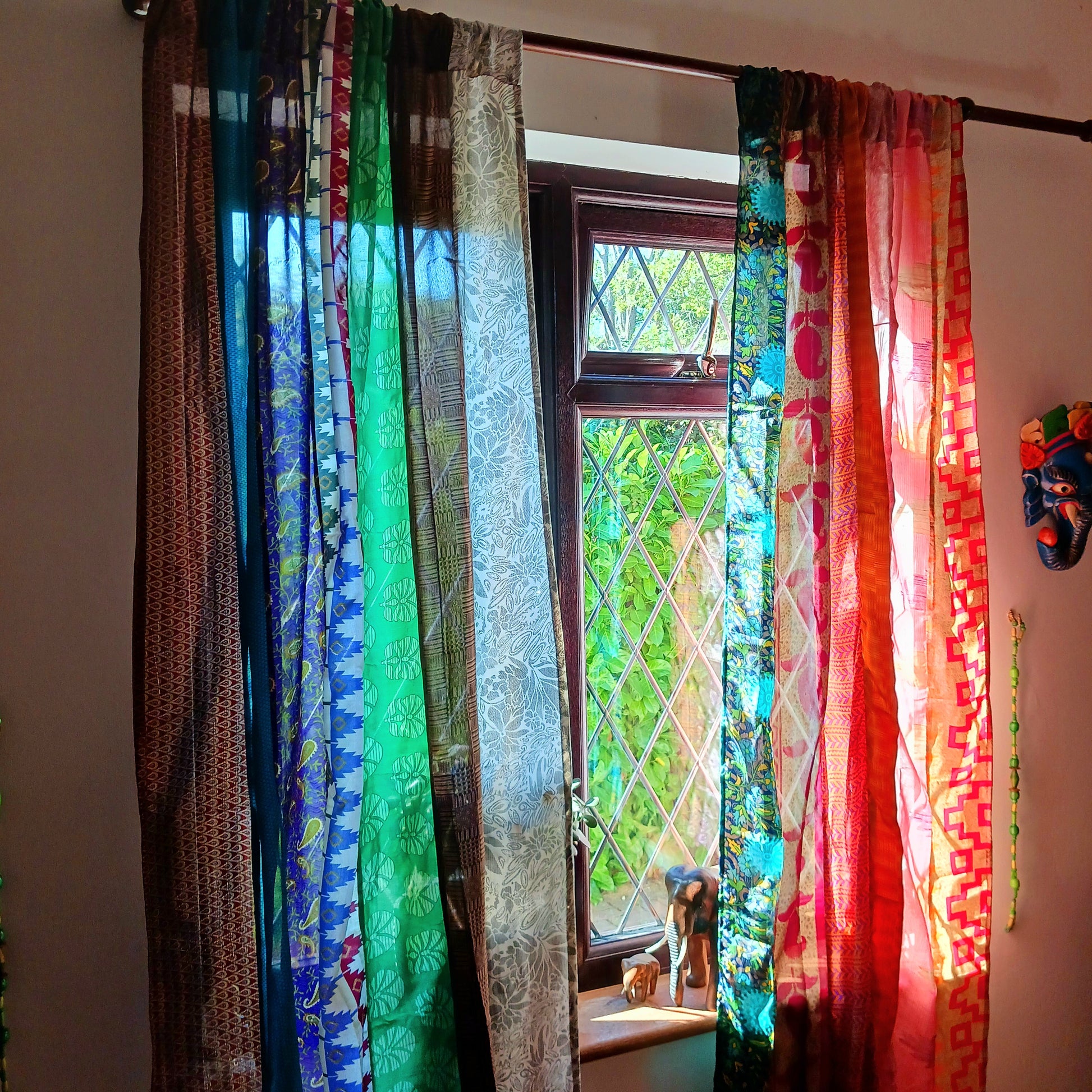 These beautiful curtains are handmade from assorted panels of Indian sari fabric, hand crafted into beautiful recycled curtain panels. The combined varieties of silky soft material are made with an easy to mount top hanging rod pocket.