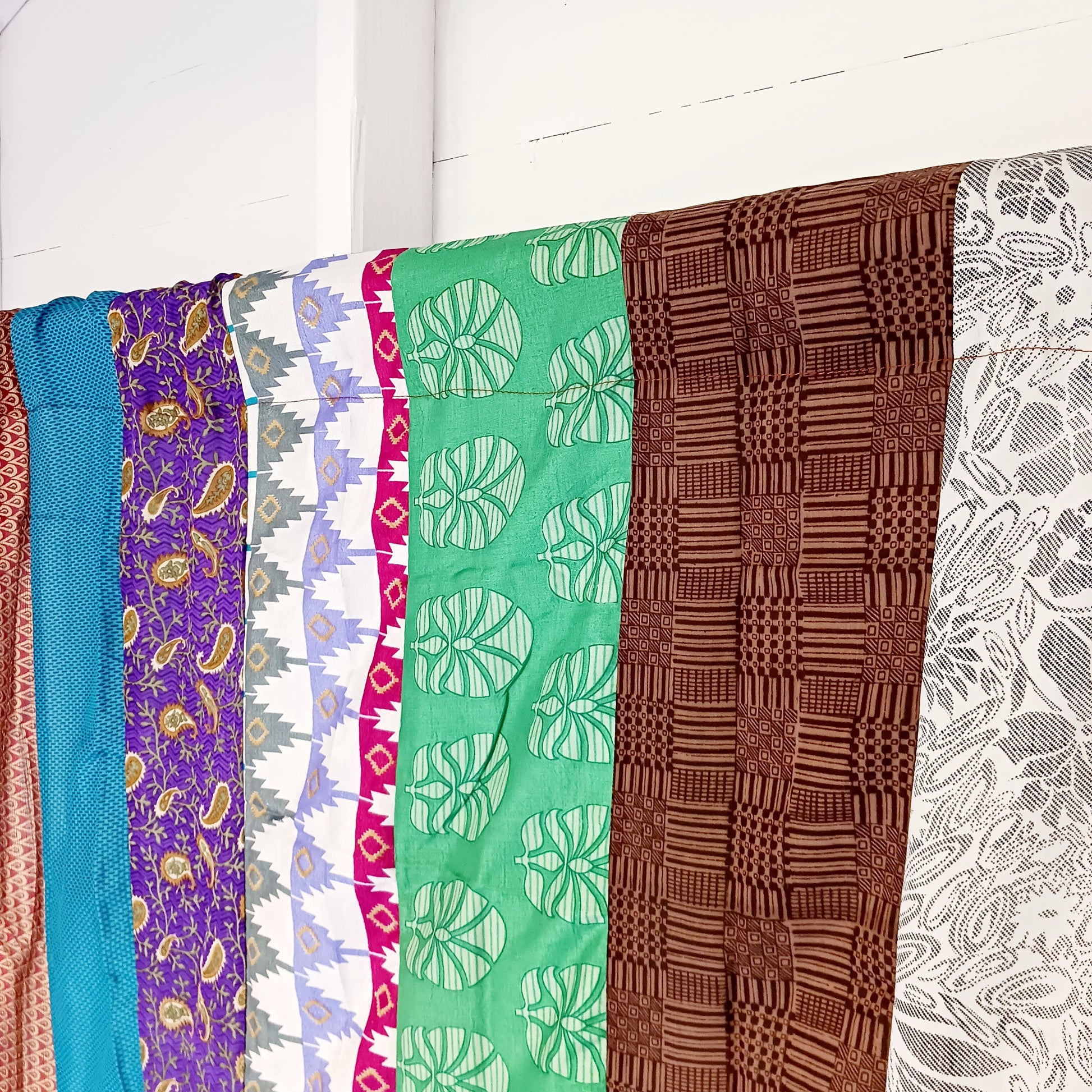 These beautiful curtains are handmade from assorted panels of Indian sari fabric, hand crafted into beautiful recycled curtain panels. The combined varieties of silky soft material are made with an easy to mount top hanging rod pocket.
