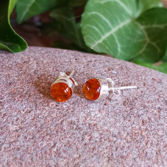 These perfect Silver Amber Stud earrings are minimal and modern jewellery box must-have! 
Handcrafted with beautiful large Amber gemstones, the stones are set within simple sterling silver frames, adding a modern and elegant touch to the natural centrepiece.  Each Amber gemstone boasts a classic cut, with dome top and perfect polish. 
Approx size 5mm