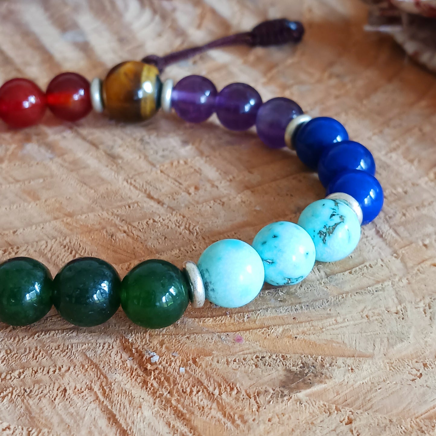 These beautiful bracelets feature chakra mala beads, multi gemstone, all natural hand knotted chakra beads. Balancing for all Seven Chakras.
A wrist mala is a string of beads used for counting mantras. The traditional number of beads for a Tibetan mala is 108, but smaller numbers such as 54, 27, 21 and 18 are also common. Spacer beads are not often included in this number but can be a personal choice for ease of use or decoration. Additional feature such as strands of counter beads, tassels, and symbolic j