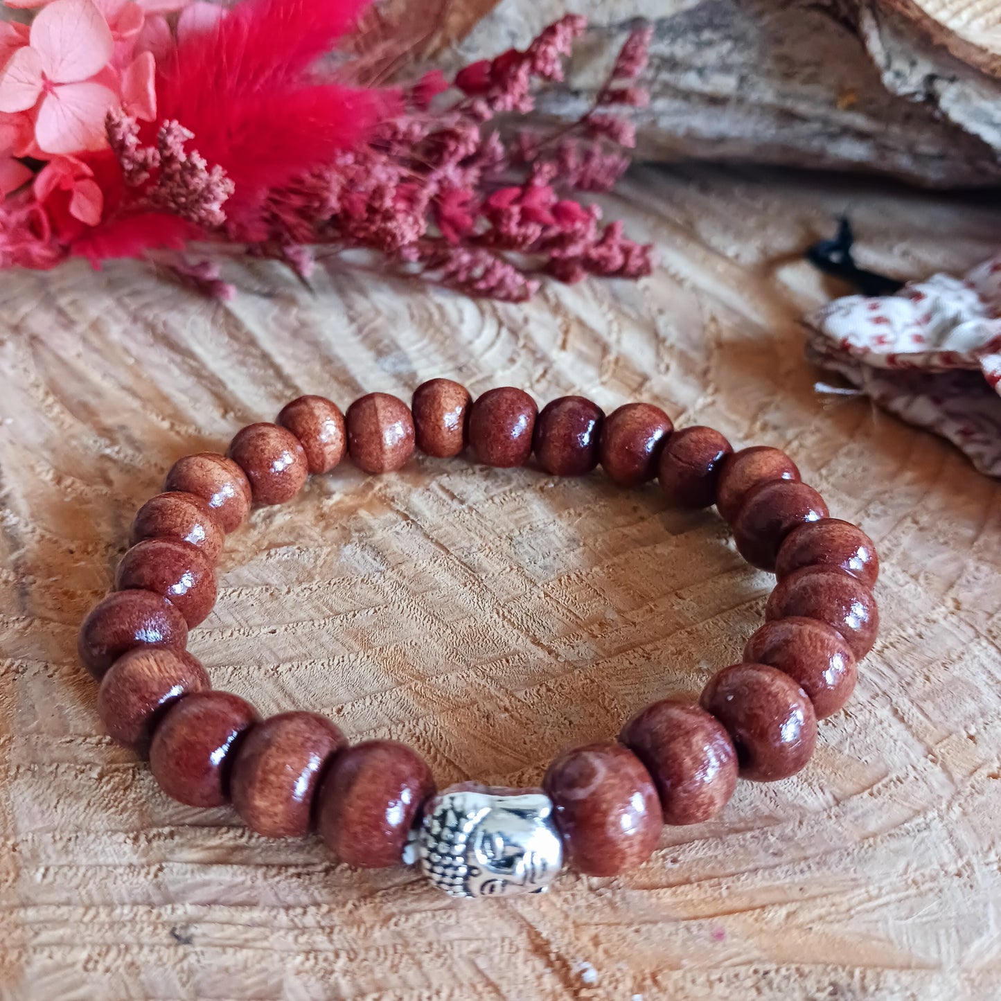 This simple wooden beaded bracelet is made from natural wood beads in a variety of sizes. The beads are strung together on a sturdy cord and in the centre is the face of Buddha.
The bracelet is gifted in a traditional Tibetan pouch.
Handmade and Fair Trade from Indonesia.
Size: Beads are approximately 5mm, one size fits all