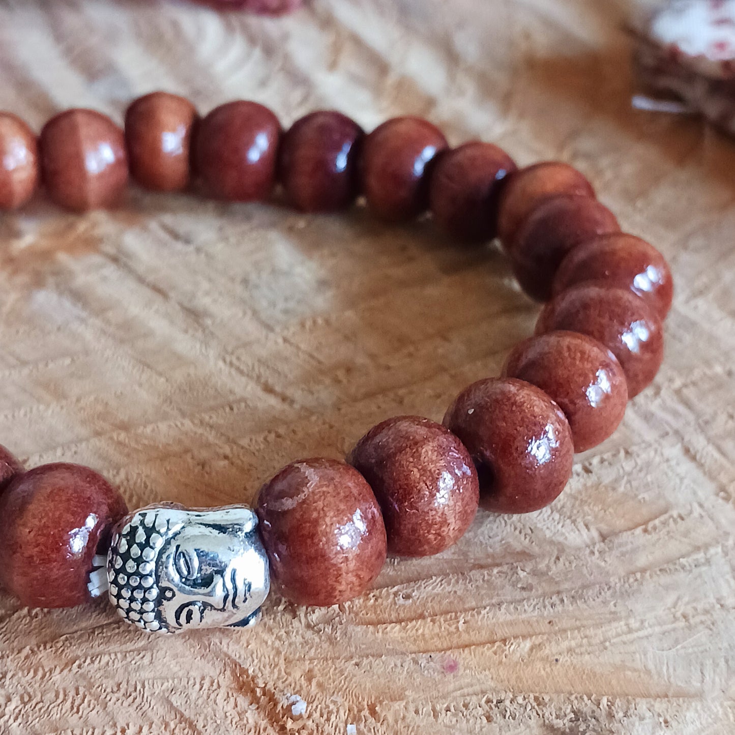 This simple wooden beaded bracelet is made from natural wood beads in a variety of sizes. The beads are strung together on a sturdy cord and in the centre is the face of Buddha.
The bracelet is gifted in a traditional Tibetan pouch.
Handmade and Fair Trade from Indonesia.
Size: Beads are approximately 5mm, one size fits all