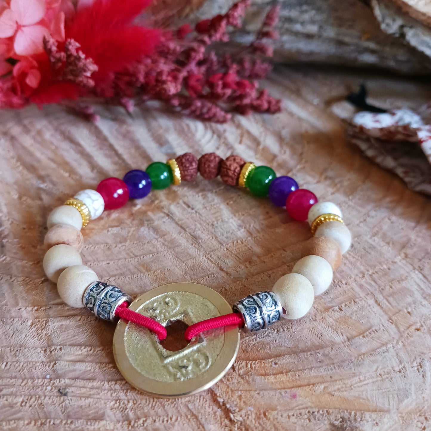 The Tri Hita Karana Power Bangles refer to the traditional philosophy of life, popular on the island of Bali, Indonesia. Tri = three, Hita = Happiness, Karana = elements.
An important part of the Tri Hita Karana philosophy is to Believe or to have faith. The elements can be summed up as God-Humans-Nature. Our faith in the divine is symbolised by the red beads. Our faith and belief in our fellow humans symbolised by the universal coin (the square in circle representing humanity in spiritual realm). Our fait