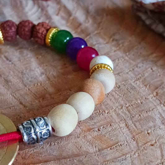 The Tri Hita Karana Power Bangles refer to the traditional philosophy of life, popular on the island of Bali, Indonesia. Tri = three, Hita = Happiness, Karana = elements.
An important part of the Tri Hita Karana philosophy is to Believe or to have faith. The elements can be summed up as God-Humans-Nature. Our faith in the divine is symbolised by the red beads. Our faith and belief in our fellow humans symbolised by the universal coin (the square in circle representing humanity in spiritual realm). Our fait