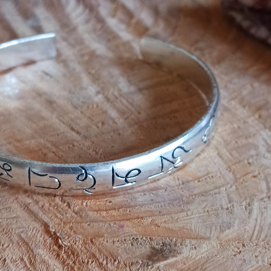 These beautifully crafted Tibetan white metal bangles feature detailed etching of the traditional Buddhist Om mani padme hum mantra.