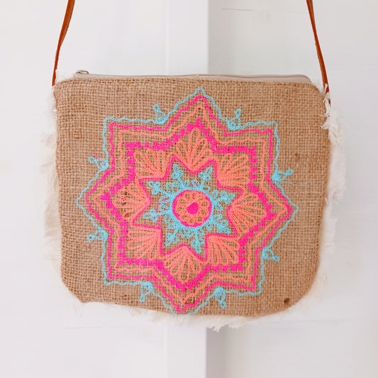 These unique and lovely bags have mandala patterns on smooth jute that has been washed with fashionable prints that are either printed or sewn onto it, and finished with a fringe. Handmade by a Balinese family business, these bags are carefully sewn by hand with intricate details.