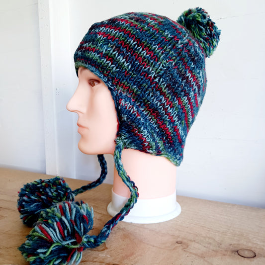 This Hasri space dye earflap hat is a fun and snuggly hat with matching pom poms.  Chunky knit from tie dye wool with a smooth fleece lining so it's lovely and comfortable to wear and keep you extra warm. Perfect for winter days out!