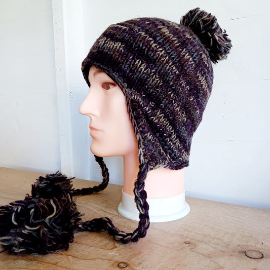 This Hasri space dye earflap hat is a fun and snuggly hat with matching pom poms. Chunky knit from tie dye wool with a smooth fleece lining so it's lovely and comfortable to wear and keep you extra warm.  Perfect for winter days out!