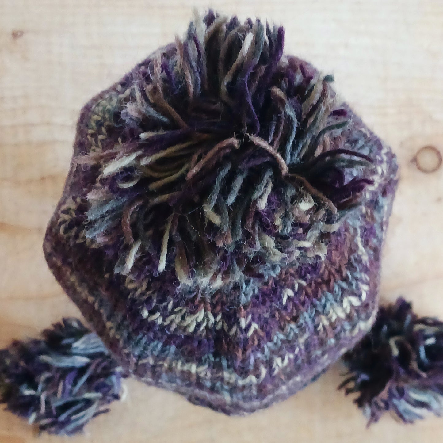 This Hasri space dye earflap hat is a fun and snuggly hat with matching pom poms. Chunky knit from tie dye wool with a smooth fleece lining so it's lovely and comfortable to wear and keep you extra warm. Perfect for winter days out!
