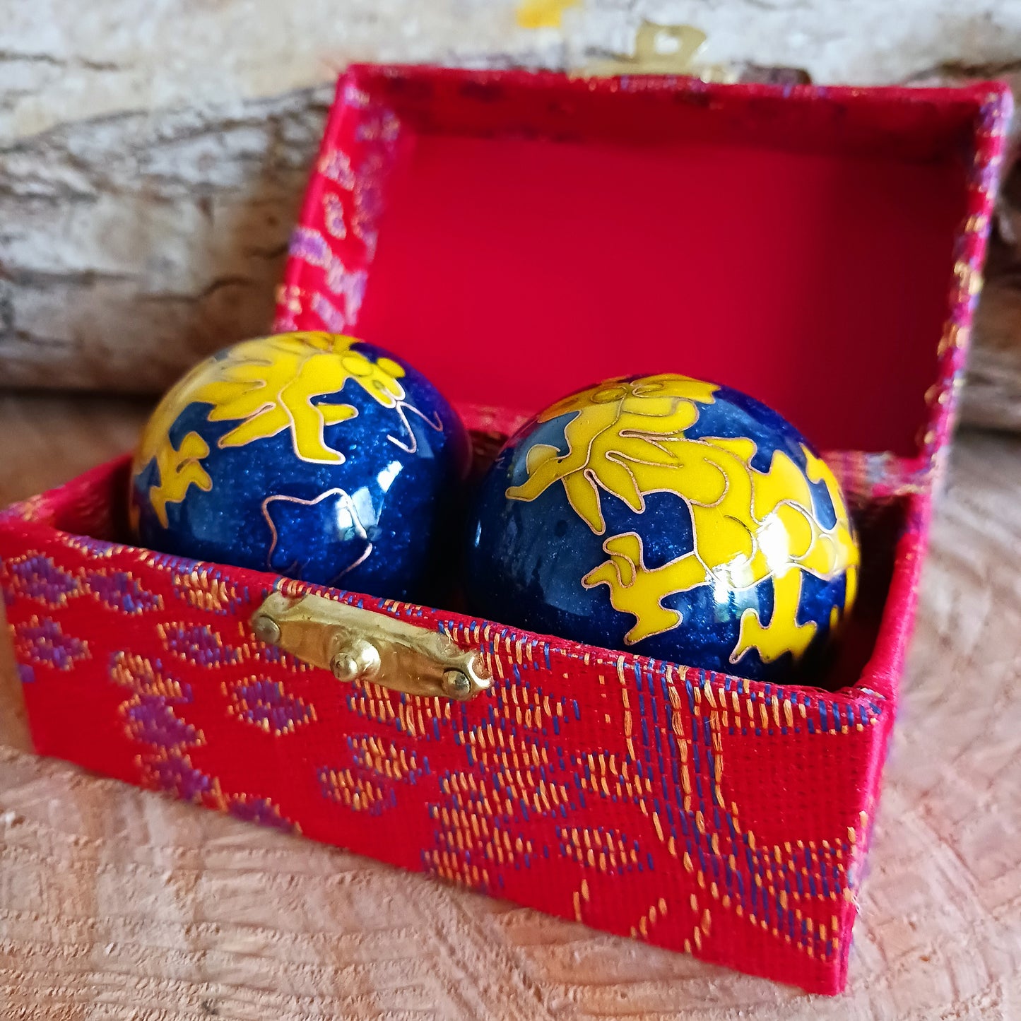 These balls are available in various sizes; start with the smaller ones, and try and roll the balls alternately to the left and to the right. If this is going well, then try and roll the balls without letting them touch each other. When you have mastered this skill, then change to the bigger size. With these you can learn to turn them even on your fingertips. After some time you will notice your hands and fingers becoming suppler.