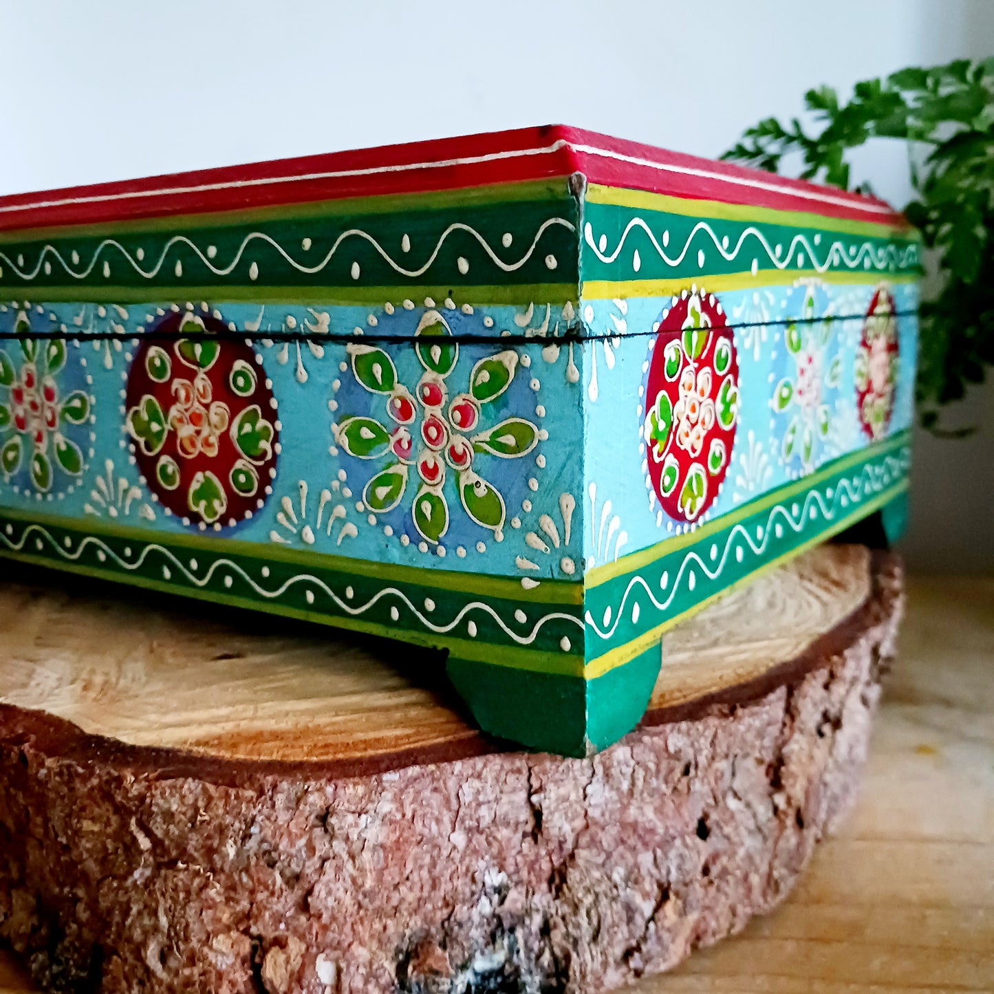 This is a large and beautiful hand made, hand painted Indian wooden jewellery box in a striking turquoise and floral pattern. The box has a hinged lid and front closure. Ideal as a decorative jewellery, trinket, keepsake box or a tidy, attractive way of hiding odds and ends.