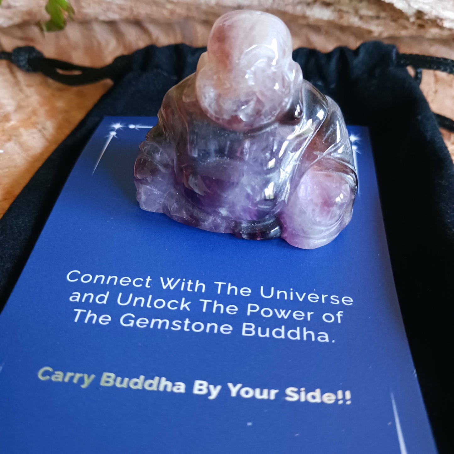 This beautiful miniature handcarved Laughing Buddha has been crafted from genuine Amethyst. This gemstone Buddha is a jolly and elegant symbol of peace, spiritual growth, and inner clarity.