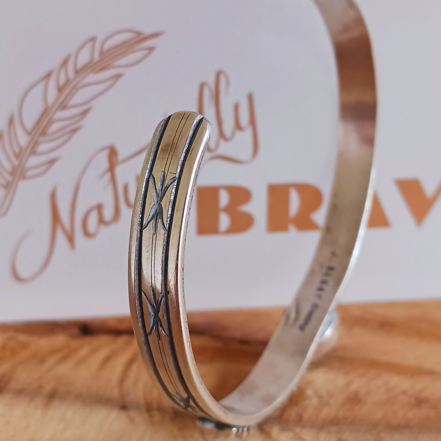 This bracelet is a stunning example of classic Navajo jewellery. This piece is handmade out of sterling silver and genuine Turquoise oval stone. The Arrows are for protection.