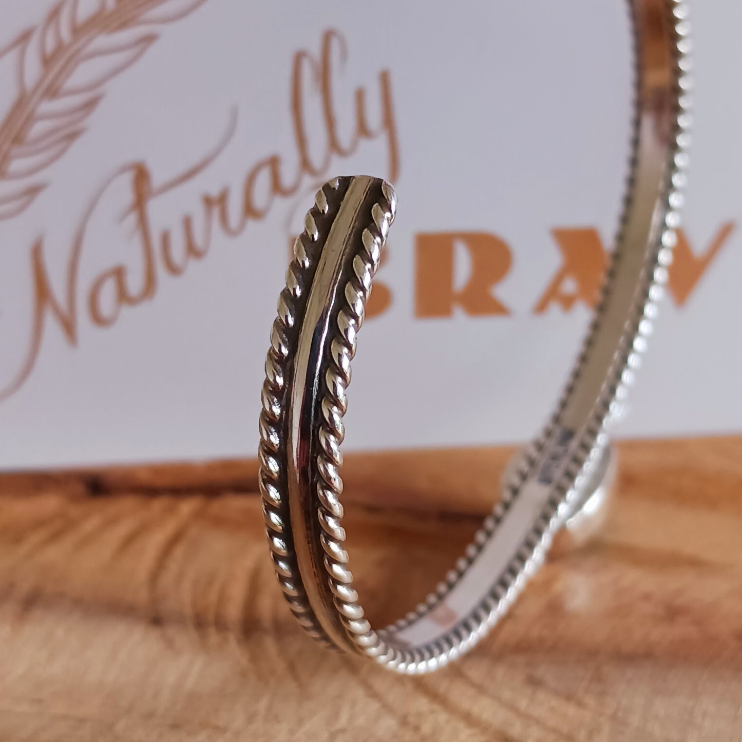 This beautiful and elegant Kingman Turquoise bracelet has been handmade by Navajo artisan Ben Jimenez. The finely crafted silver band is complemented by a stunning Turquoise stone at the centre. This is the artistry of Ben Jimenez who has developed such a distinctive style.