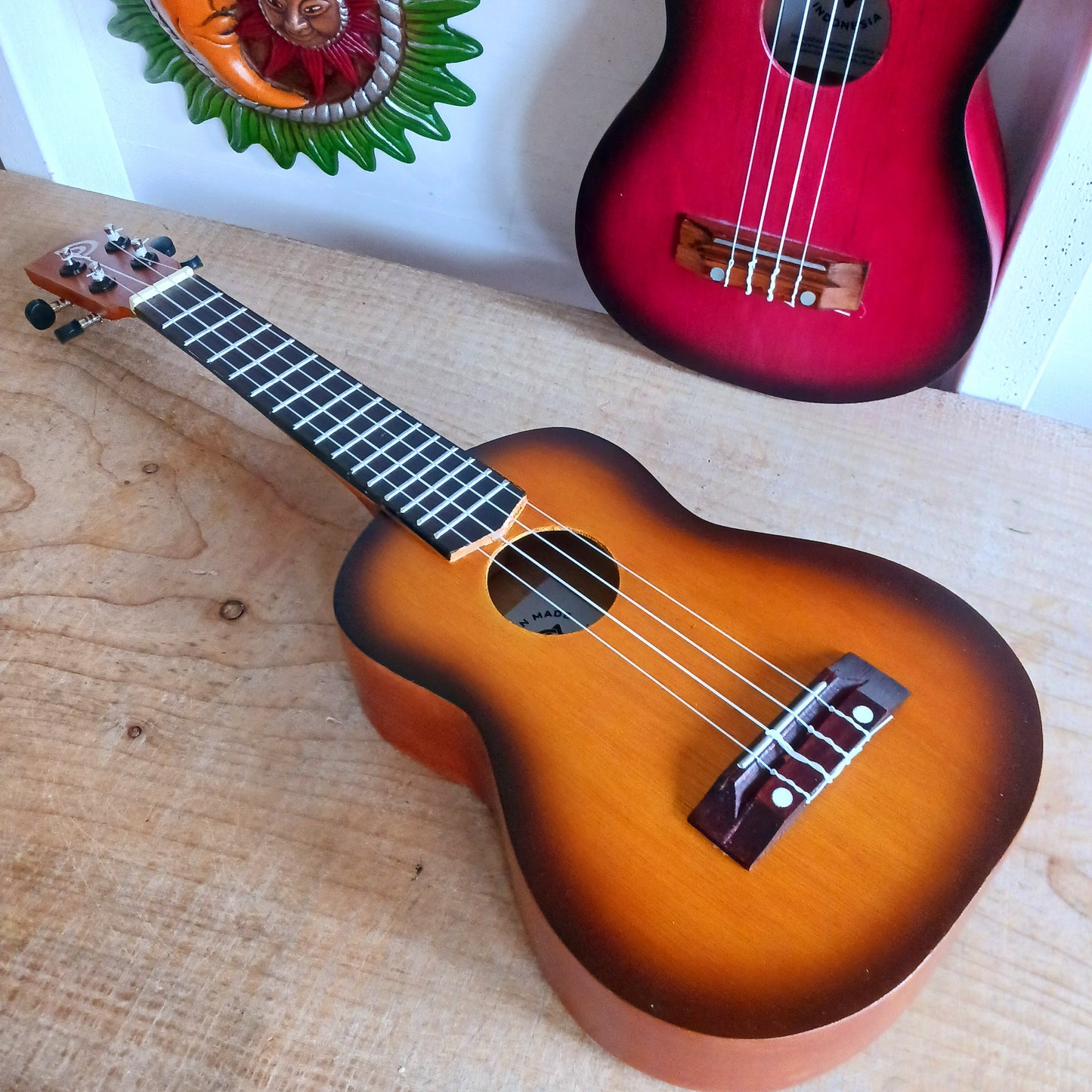 These handmade Artisan Ukuleles are beautifully handcrafted instruments from Indonesia. Featuring a natural sunburst finish, these 4-string ukuleles combine exceptional quality with vibrant visual appeal. Their high-quality construction ensures warm, resonant tones that are perfect for a variety of musical styles.