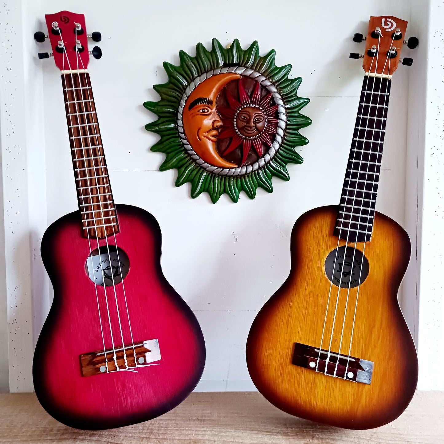 These handmade Artisan Ukuleles are beautifully handcrafted instruments from Indonesia. Featuring a natural sunburst finish, these 4-string ukuleles combine exceptional quality with vibrant visual appeal. Their high-quality construction ensures warm, resonant tones that are perfect for a variety of musical styles.