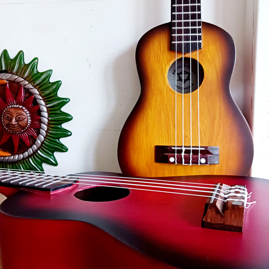 These handmade Artisan Ukuleles are beautifully handcrafted instruments from Indonesia. Featuring a natural sunburst finish, these 4-string ukuleles combine exceptional quality with vibrant visual appeal. Their high-quality construction ensures warm, resonant tones that are perfect for a variety of musical styles.