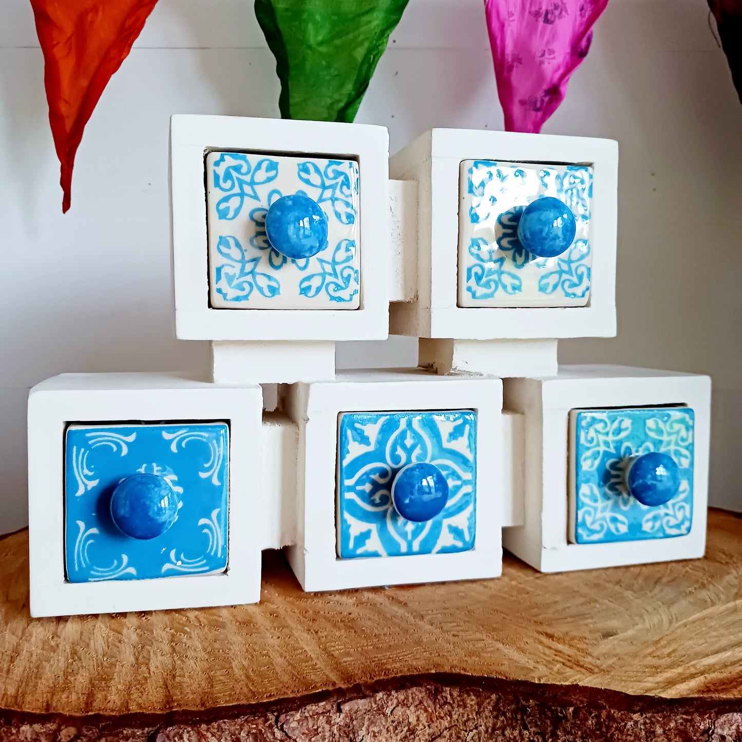 These attractive and unusual ceramic drawers are perfect for storing a hundred things! Spices, buttons, keys, trinkets, safety pins, haberdashery, knickknacks, all bits & bobs. The wood used is mango wood and the ceramic drawers are all hand painted.