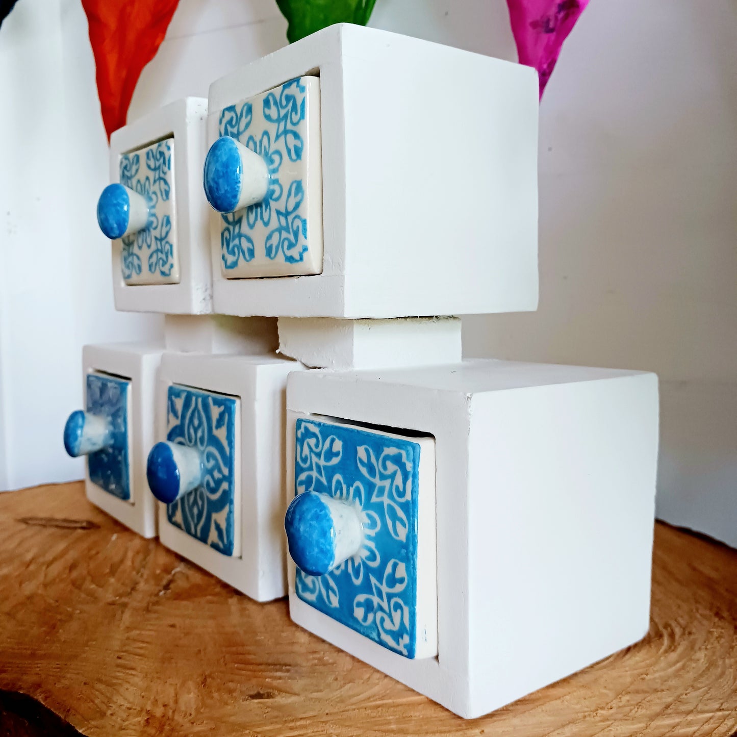 These attractive and unusual ceramic drawers are perfect for storing a hundred things! Spices, buttons, keys, trinkets, safety pins, haberdashery, knickknacks, all bits & bobs. The wood used is mango wood and the ceramic drawers are all hand painted.