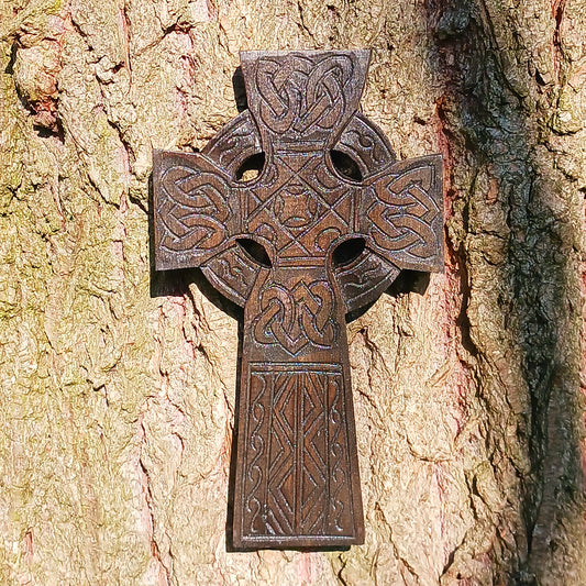 This detailed and lightweight wooden carved Celtic cross is a lovely little piece that has carvings featuring Celtic style knots and etchings.