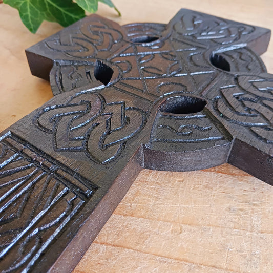 This detailed and lightweight wooden carved Celtic cross is a lovely little piece that has carvings featuring Celtic style knots and etchings.