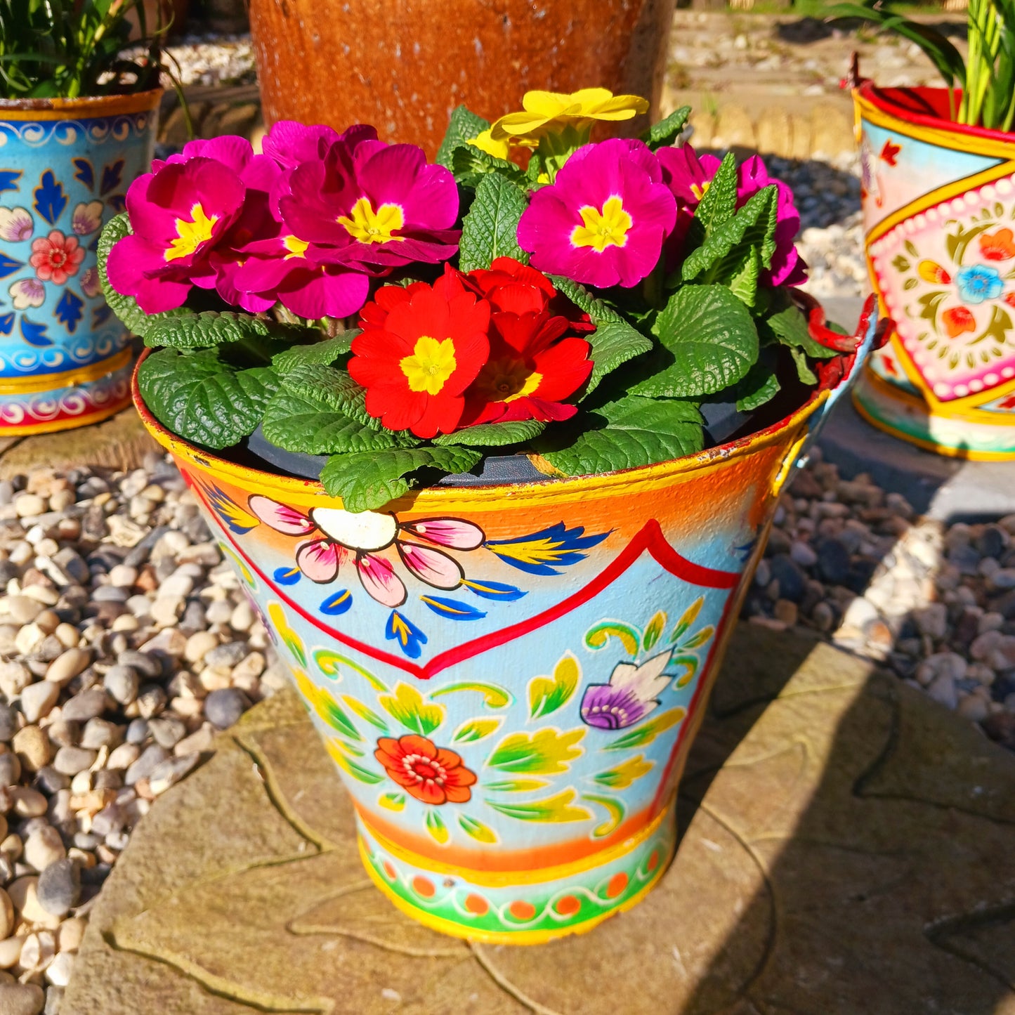 Hand painted in a turquoise floral design, a vintage style iron plant pot to display as a decorative indoor/outdoor planter. Lovingly hand painted by skilled artisans on a fair trade basis in the Indian desert city of Jodhpur. Fill the striking container with a flowering or contrasting potted plant. Grow seasonal bulbs to bring life and inspiration.