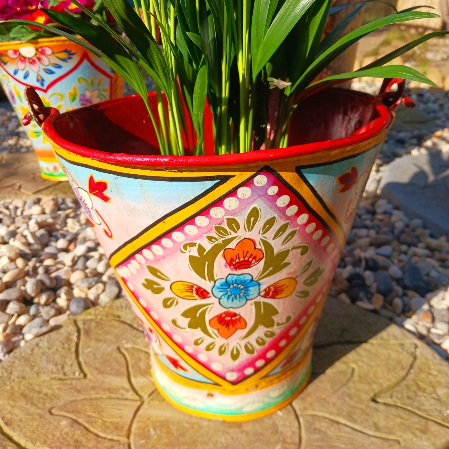 Hand painted in a pink floral design, a vintage style iron plant pot to display as a decorative indoor/outdoor planter.
Lovingly hand painted by skilled artisans on a fair trade basis in the Indian desert city of Jodhpur. Fill the striking container with a flowering or contrasting potted plant. Grow seasonal bulbs to bring life and inspiration.