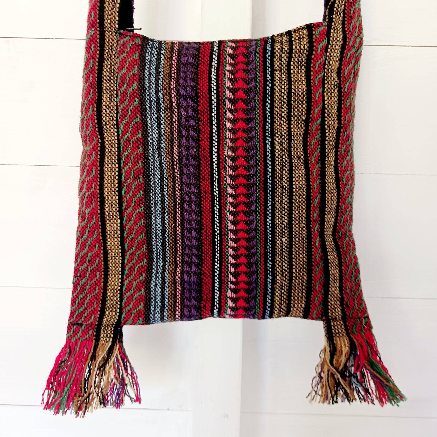 This handy little shoulder bag has a wide strap that is long enough to use as a shoulder or crossbody bag and also makes it comfortable to wear for long periods. The main fabric is traditional with a beautiful embroidered decorated elephants on the front. The bag is finished with tassels.
