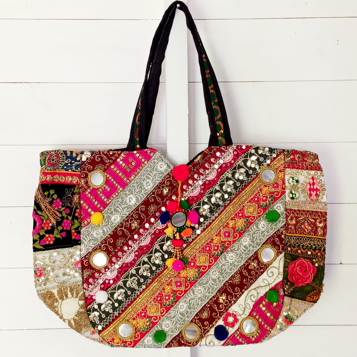 This beautiful large Indian bag comes with a wide shoulder strap and plenty of space inside for your personal items. In a patchwork style design, this bag is intricately embroidered with a traditional bohemian pattern. The bag is fully lined throughout.