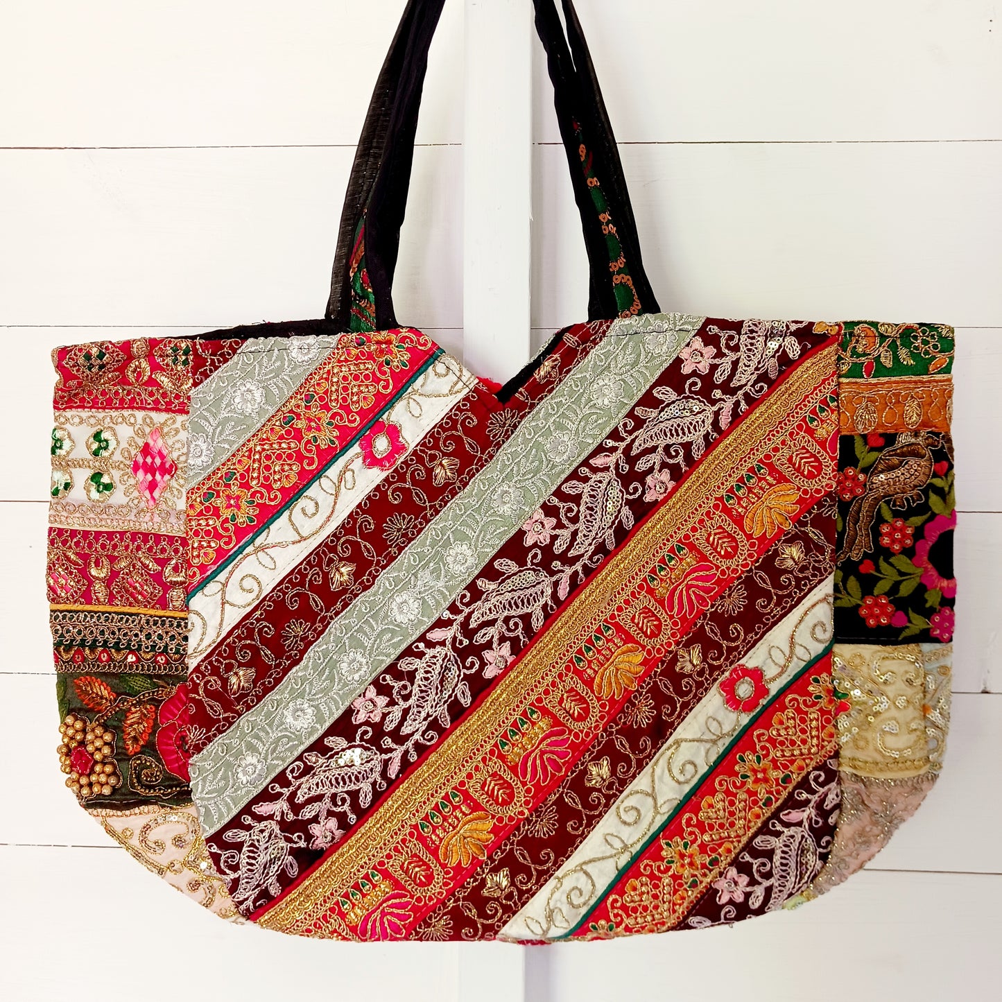 This beautiful large Indian bag comes with a wide shoulder strap and plenty of space inside for your personal items. In a patchwork style design, this bag is intricately embroidered with a traditional bohemian pattern. The bag is fully lined throughout.