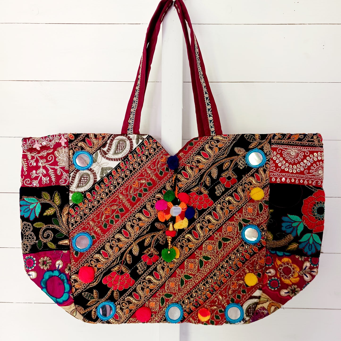 This beautiful large Indian bag comes with a wide shoulder strap and plenty of space inside for your personal items. In a patchwork style design, this bag is intricately embroidered with a traditional bohemian pattern. The bag is fully lined throughout.