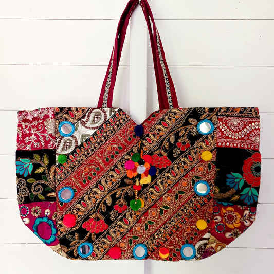 This beautiful large Indian bag comes with a wide shoulder strap and plenty of space inside for your personal items. In a patchwork style design, this bag is intricately embroidered with a traditional bohemian pattern. The bag is fully lined throughout.