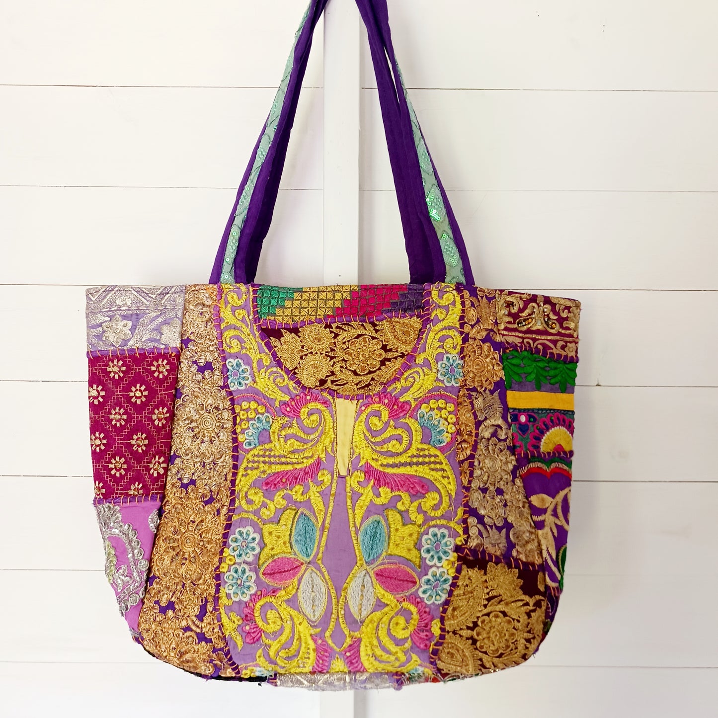 This beautiful large Indian bag comes with a wide shoulder strap and plenty of space inside for your personal items. In a patchwork style design, this bag is intricately embroidered with a traditional bohemian pattern. The bag is fully lined throughout.