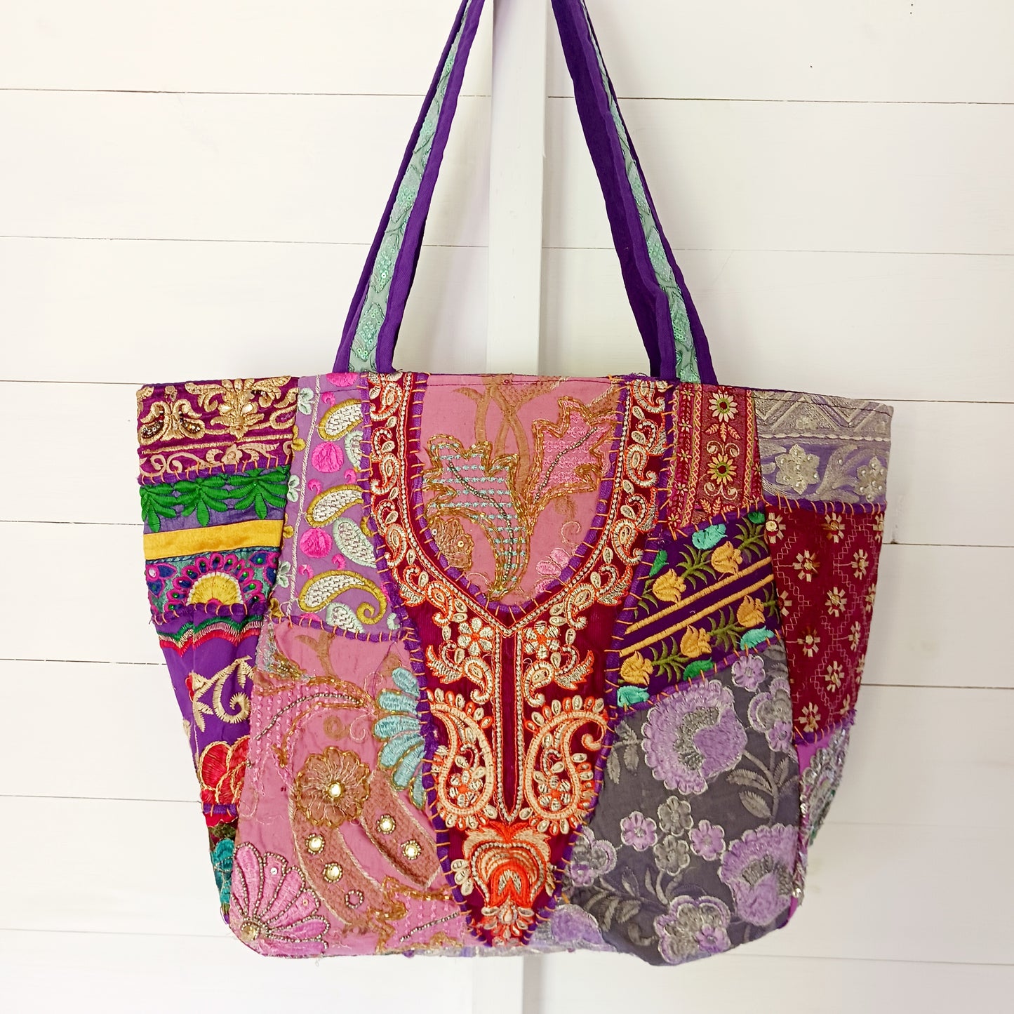 This beautiful large Indian bag comes with a wide shoulder strap and plenty of space inside for your personal items. In a patchwork style design, this bag is intricately embroidered with a traditional bohemian pattern. The bag is fully lined throughout.