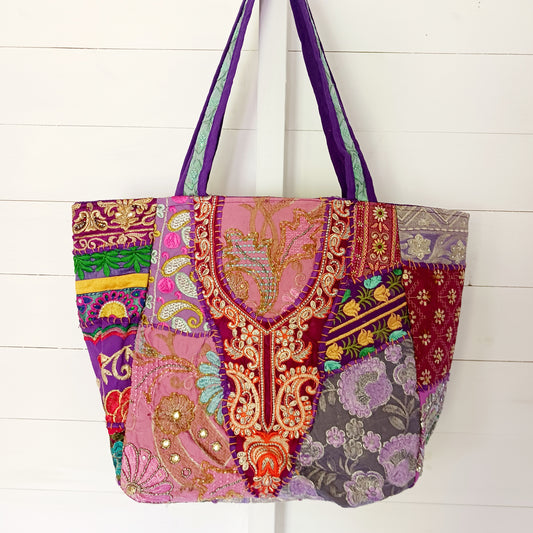 This beautiful large Indian bag comes with a wide shoulder strap and plenty of space inside for your personal items. In a patchwork style design, this bag is intricately embroidered with a traditional bohemian pattern. The bag is fully lined throughout.