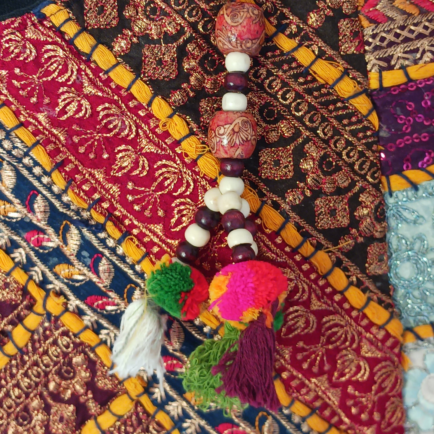 This beautiful large Indian tote bag comes with a wide shoulder strap and plenty of space inside for your personal items. In a patchwork style design, this bag is intricately embroidered with a traditional bohemian pattern.The bag comes decorated with beads and pom poms and is fully lined throughout.
