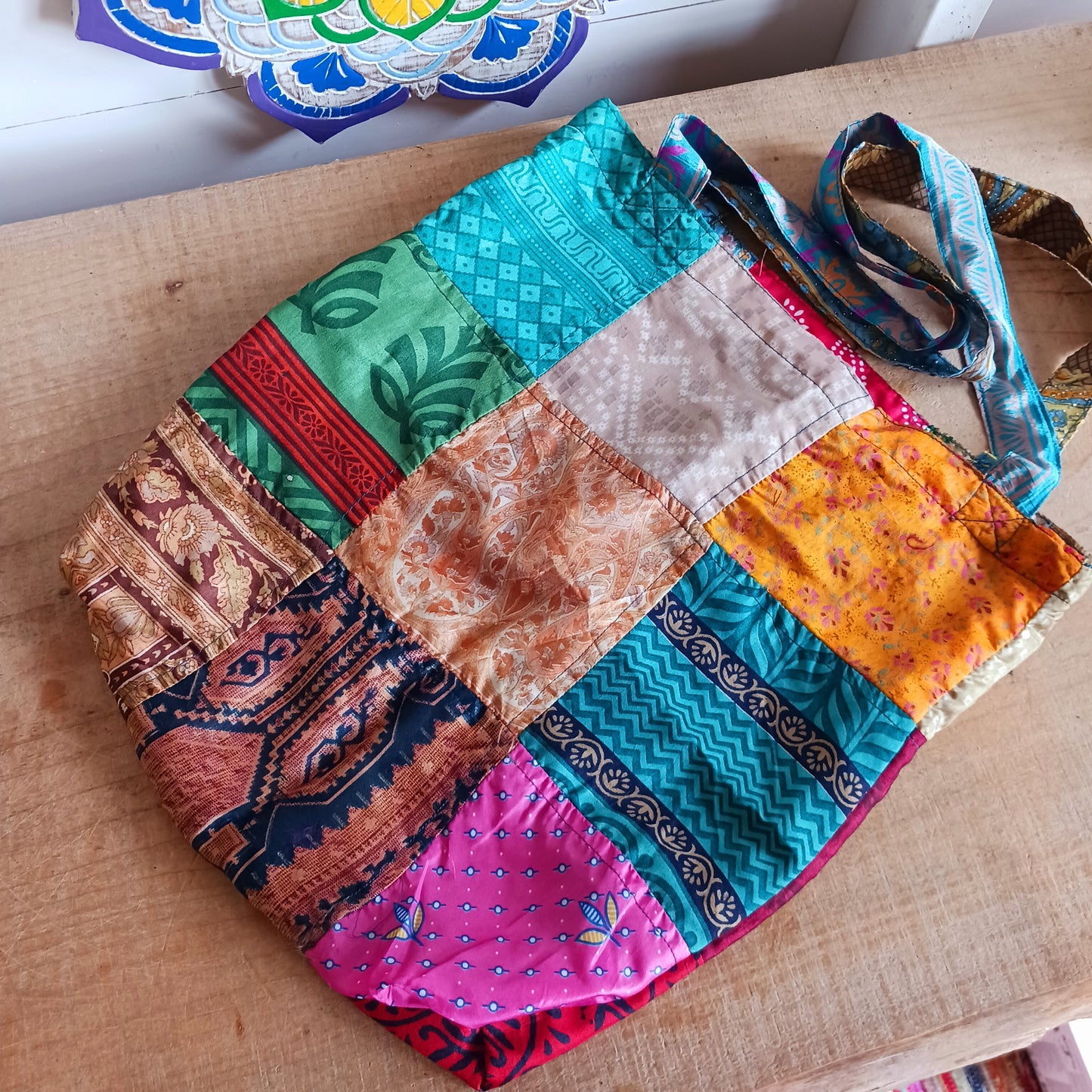 Shop like a pro! Pack this strong yet lightweight tote bag of colourful sari fabric with a black polyester lining. It's perfect for stuffing in your backpack, PC bag, cabin case, or glove box. The bag features a handy zippered external pocket for small bits and bobs like keys and coins.
