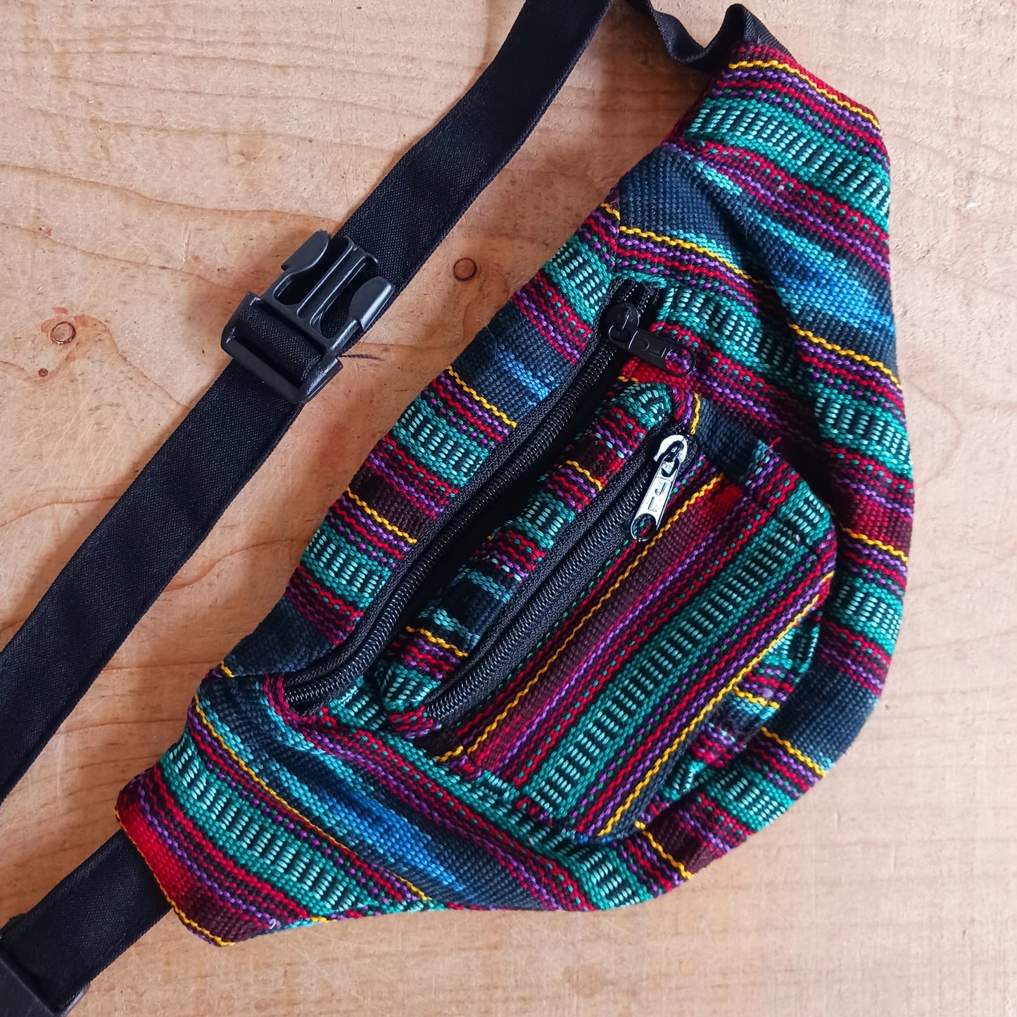 A festival favourite, these funky cotton Guatemalan bum bags come in mixed patterns. Each hip bag has three zipped compartments for organizing your valuables and a long adjustable belt strap with clasp. Perfect for holidays, the beach and festivals. Handmade and Fairtrade from Guatemala