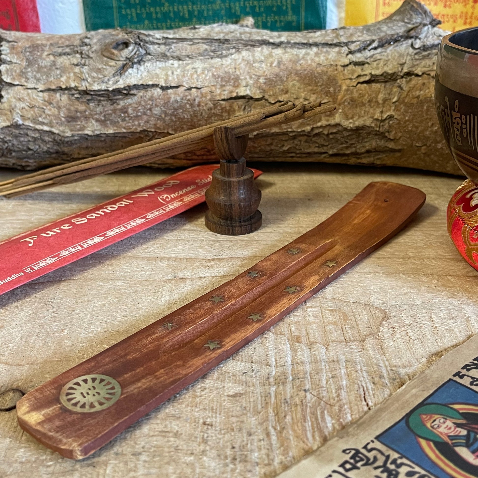 Discover our most popular incense holder yet: a stunning shoe horn-style ash catcher crafted from mango wood. Designed specifically for stick incense, this elegant piece features beautiful inlays of stars and a radiant sun.
The incense lays gracefully over the wooden body, allowing ash to collect neatly as it falls, ensuring your space remains clean and inviting.