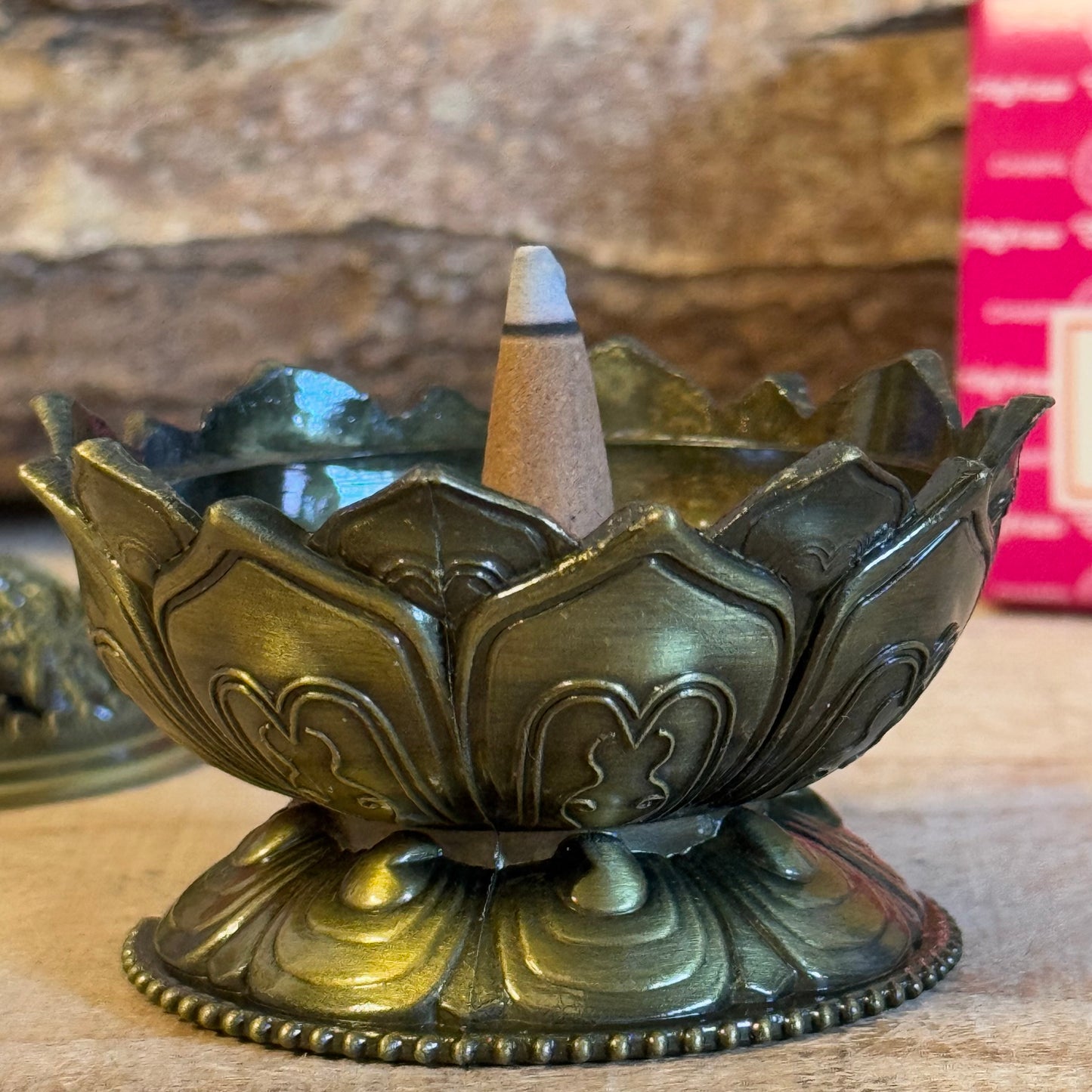 Enhance your home’s ambiance with this beautiful brass cone holder, thoughtfully designed in the shape of a lotus flower. Whether used for burning incense cones or as a charming decorative piece, this holder is both functional and elegant.
Key Features:
Elegant Lotus Design: The intricate lotus flower shape symbolizes purity and serenity, making it a meaningful addition to any space.
Majestic Smoke Display: Watch as the smoke gracefully curls through the lid’s opening, creating a soothing and captivating e
