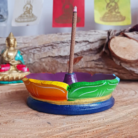 Bring serenity and spiritual balance into your space with this Hand Painted Tibetan Lotus Incense Holder. Lovingly crafted in Nepal by skilled artisans, this incense burner is made from natural wood and beautifully painted in the seven chakra colours, symbolizing harmony and enlightenment.