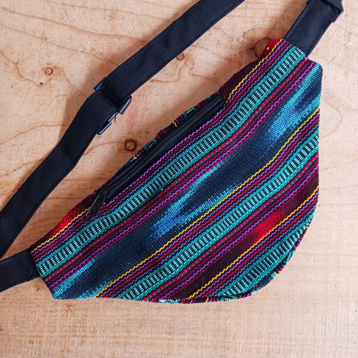 A festival favourite, these funky cotton Guatemalan bum bags come in mixed patterns. Each hip bag has three zipped compartments for organizing your valuables and a long adjustable belt strap with clasp. Perfect for holidays, the beach and festivals. Handmade and Fairtrade from Guatemala
